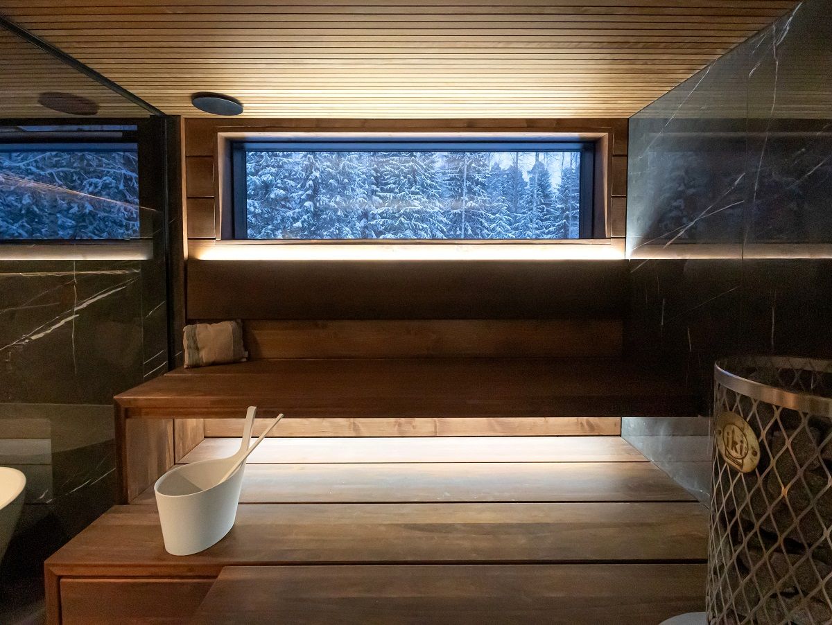 Sauna lighting indirectly from behind the backrest and under the ceiling, shot from the front